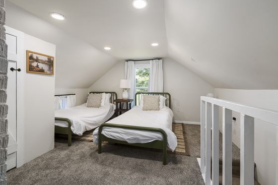The upstairs loft with two twin beds under a sloped ceiling.