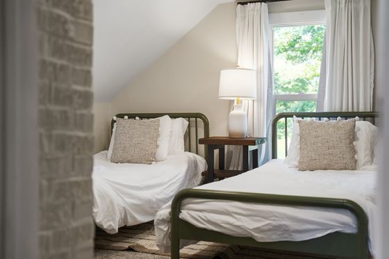 The two twin beds in the loft, beside the upstairs window.