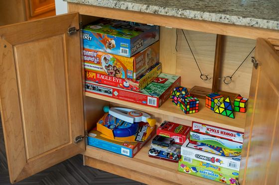 Open cabinet stacked with board games and puzzles.