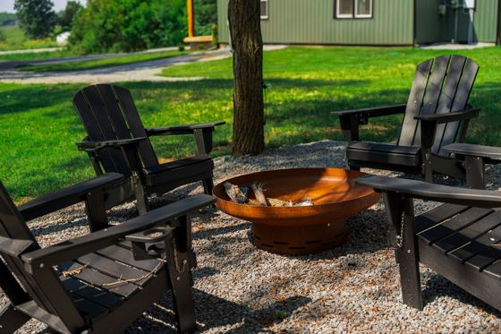 Close view of the fire bowl with chairs pulled around it.