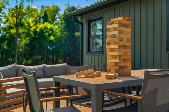 Patio table set for a game, with giant stacking blocks alongside.
