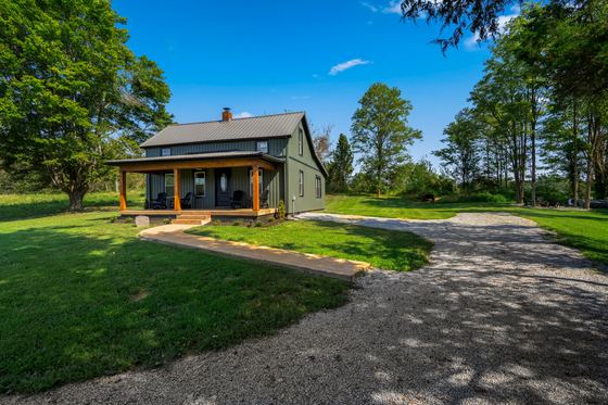 Wide lawn and gravel drive running up to the house.